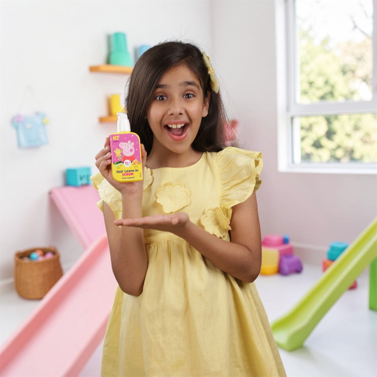 Happy Young Girl Holding KT Kids Peppa Pig Hair Leave-In Serum in Playroom - Kids Hair Care Lifestyle Photo, Children's Frizz Control Serum
